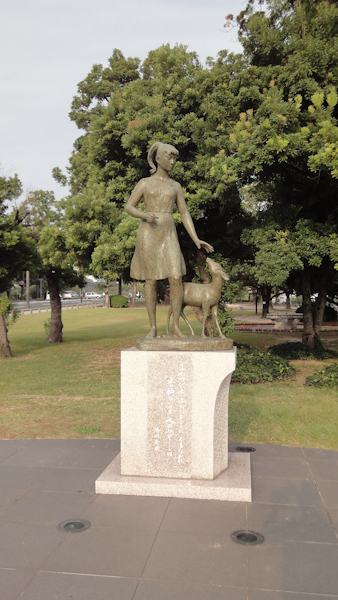 a statue of a girl and a fawn
